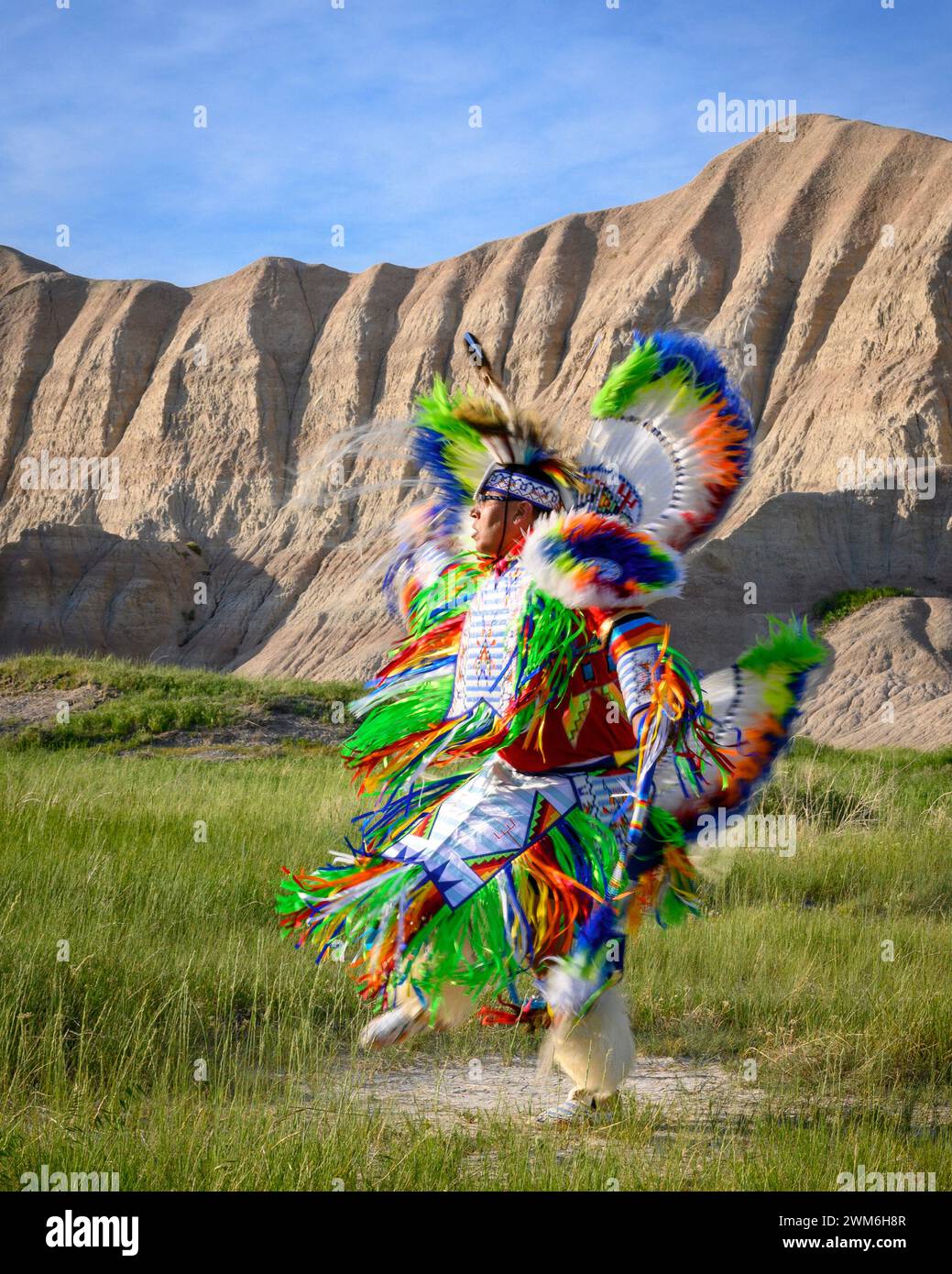 Geremiah Holy Bull performing a Fancy Dance in Badlands National Park, South Dakota. Stock Photo