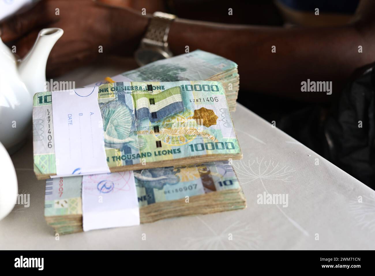 General views of bundles of Leone notes, the currency of Sierra Leone. Pictured in Freetown, Sierra Leone, Africa. Stock Photo