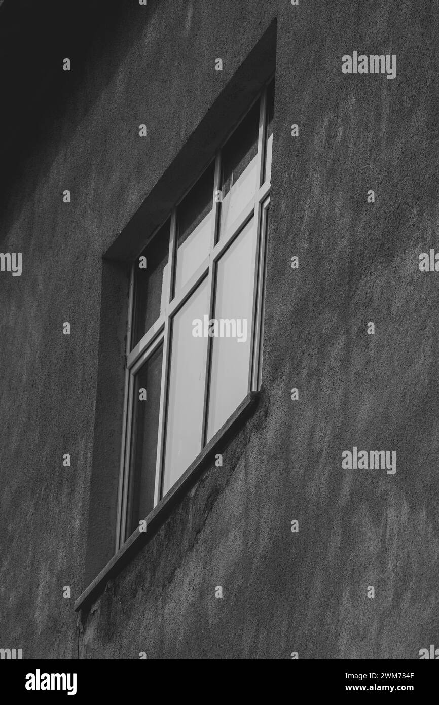 Exploring the elegance of oblique angle window glass frames. Reflection in architectural design. Wall background facade. Black and white, monochrome. Stock Photo