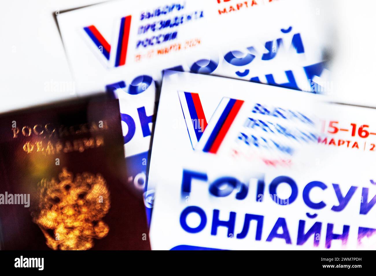 Moscow, Russia. 23rd of February, 2024. A passport of a citizen of the Russian Federation and flyers with information about the presidential elections of the Russian Federation are on white background. The banner reads 'Vote online' Stock Photo