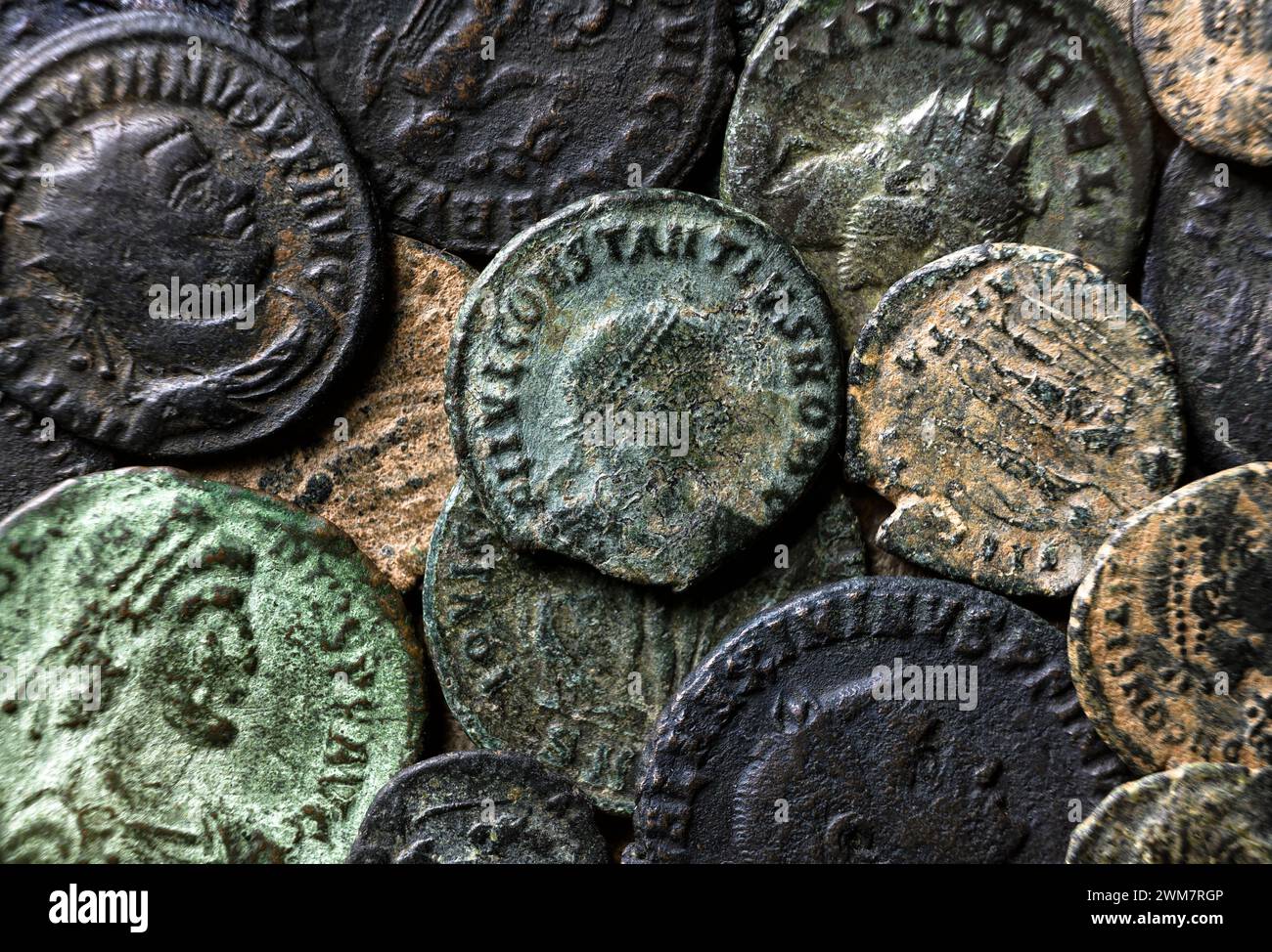 Ancient Roman coins with emperors portraits close-up, pile of old metal money, top view of vintage pattern background. Concept of Rome, Empire, textur Stock Photo