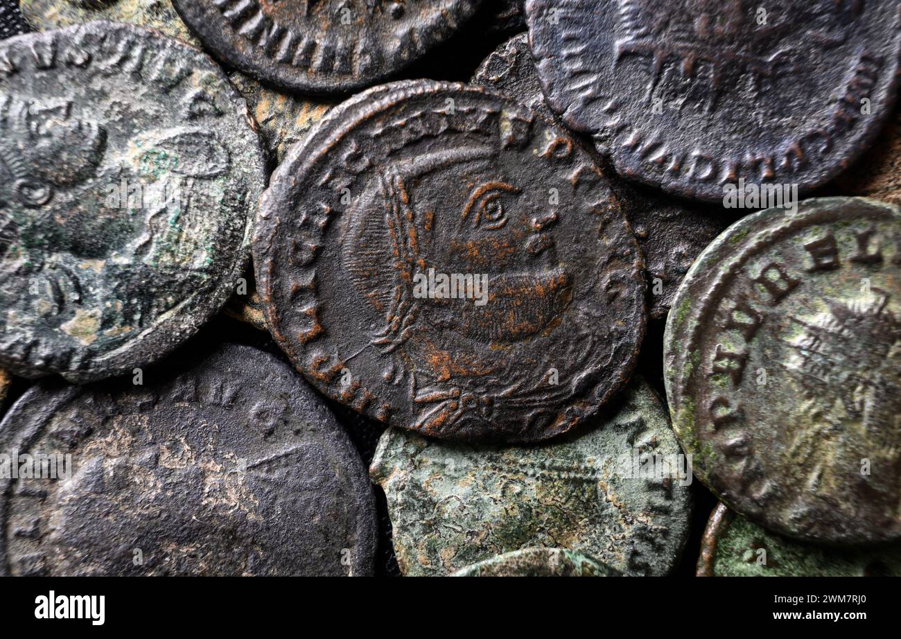 Ancient Roman coins close-up, portrait of emperor Licinius in center, pile of old money, top view of vintage background. Concept of Rome, Empire, text Stock Photo