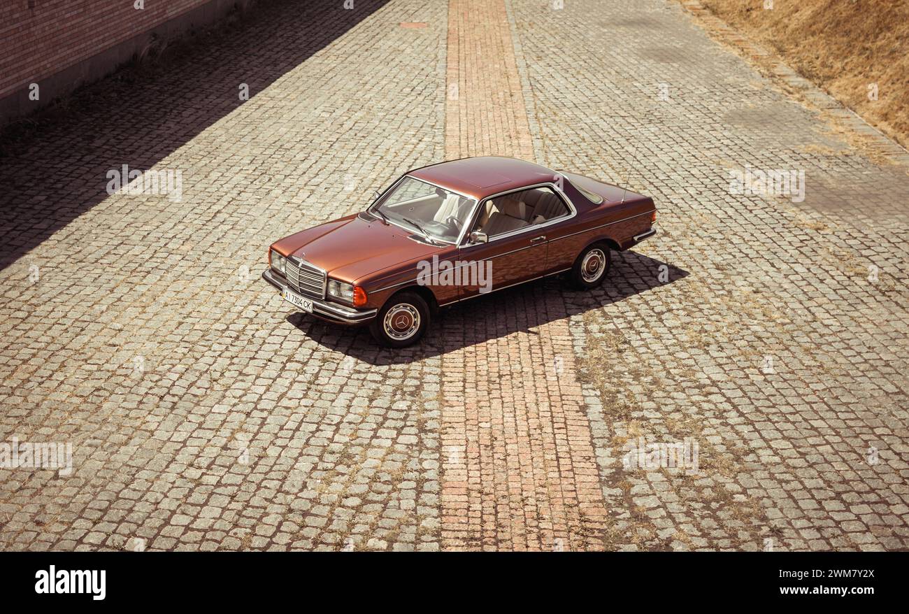 Brown classic Mercedes-Benz W123 coupe from 1970s. Three quarter view from above of brown old car Stock Photo