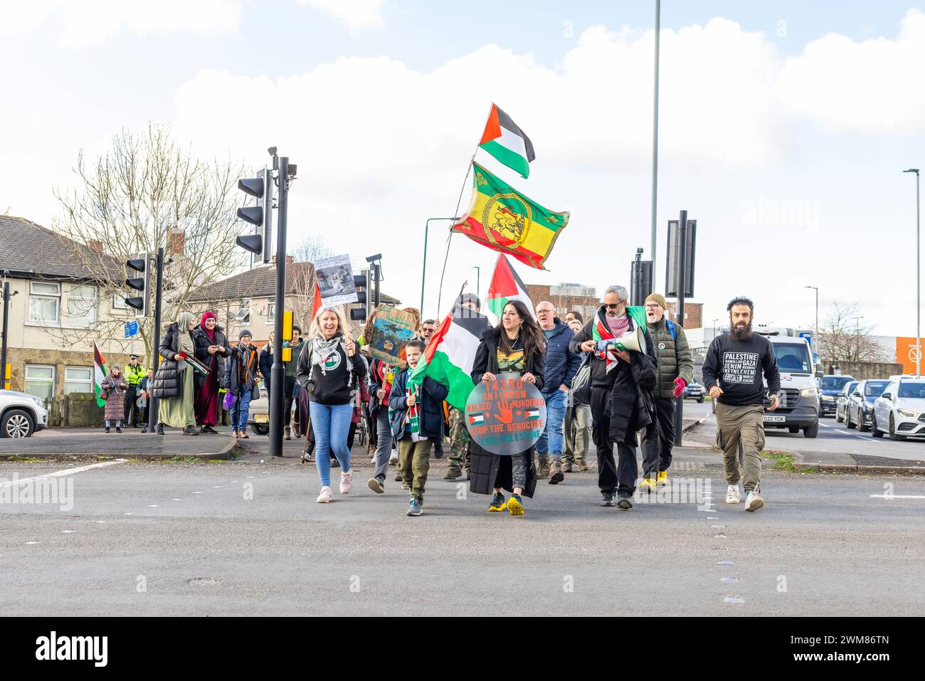 Bradford, UK. 24 FEB, 2024.  Group of Pro Palestine protestors arrive at the starting point for Bradford demo after marching from Huddersfield. Located at the junction of Gipsy ST and Leeds RD.  Credit Milo Chandler/Alamy Live News Stock Photo