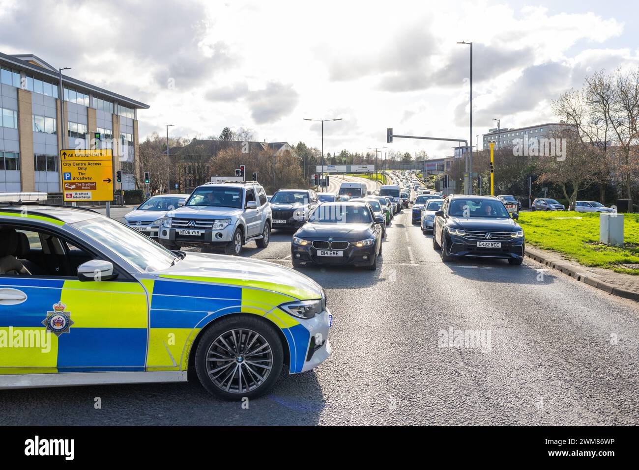 Bradford, UK. 24 FEB, 2024. Police stop traffic at intesection of the A650 and Leeds RD to facilitate passing of Pro Palestine protest. Credit Milo Chandler/Alamy Live News Stock Photo