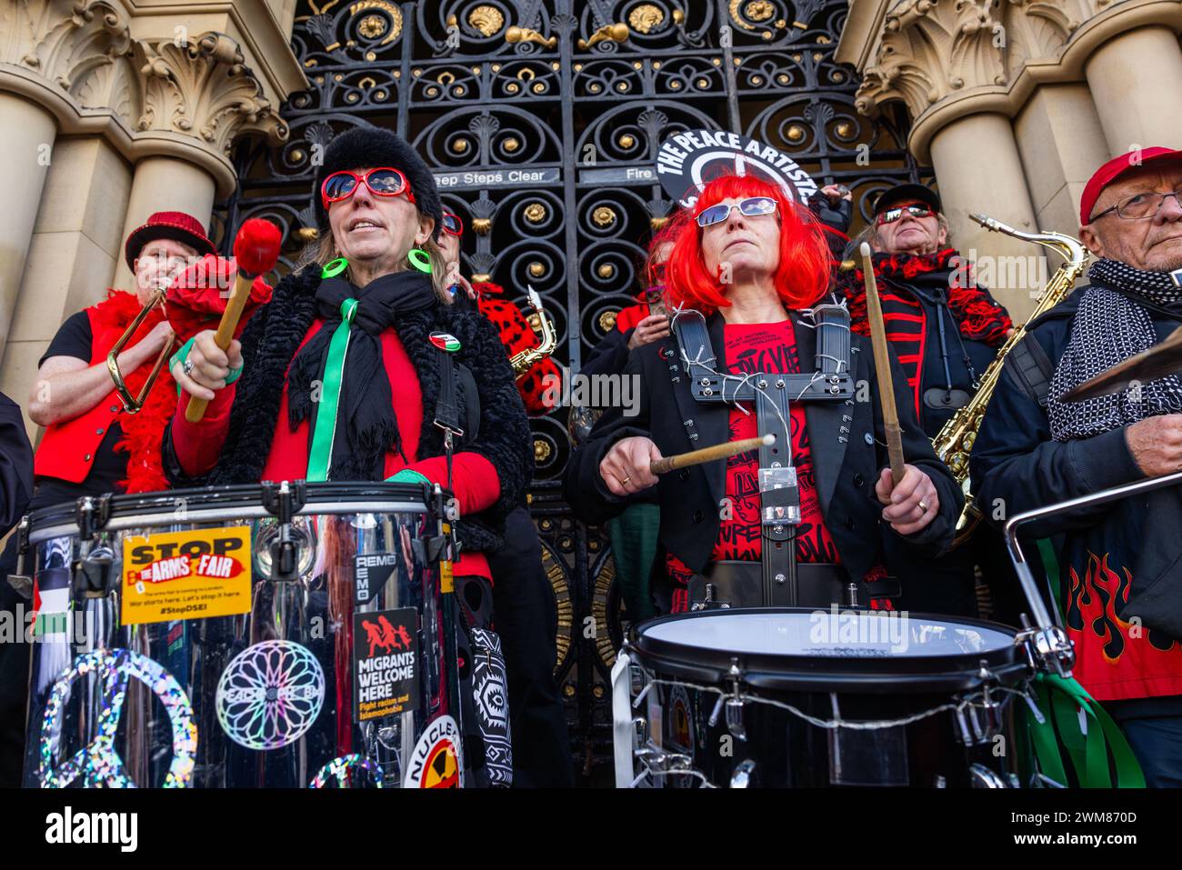 Bradford, UK. 24 FEB, 2024.  Members of the Peace artistes street band on the steps of steps of Centenary Square, Bradford. Credit Milo Chandler/Alamy Live News Stock Photo