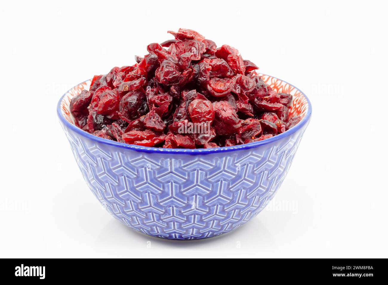 Dried cranberries in a porcelain bowl. Selective focus with shallow depth of field. Stock Photo