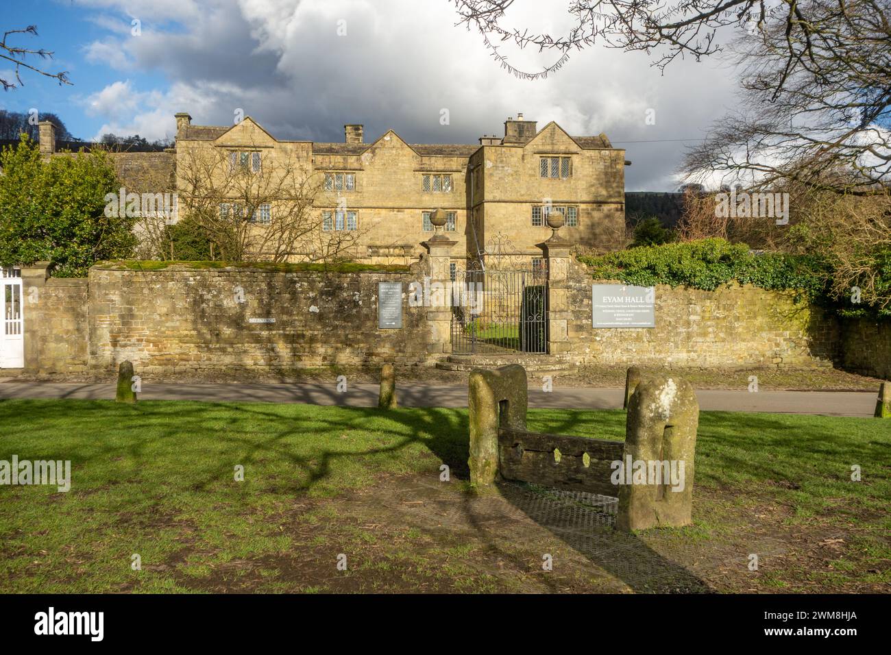 Eyam Hall, a Jacobean style manor house in the Derbyshire Peak District plague village of Eyam England seen from the stocks on the village green Stock Photo