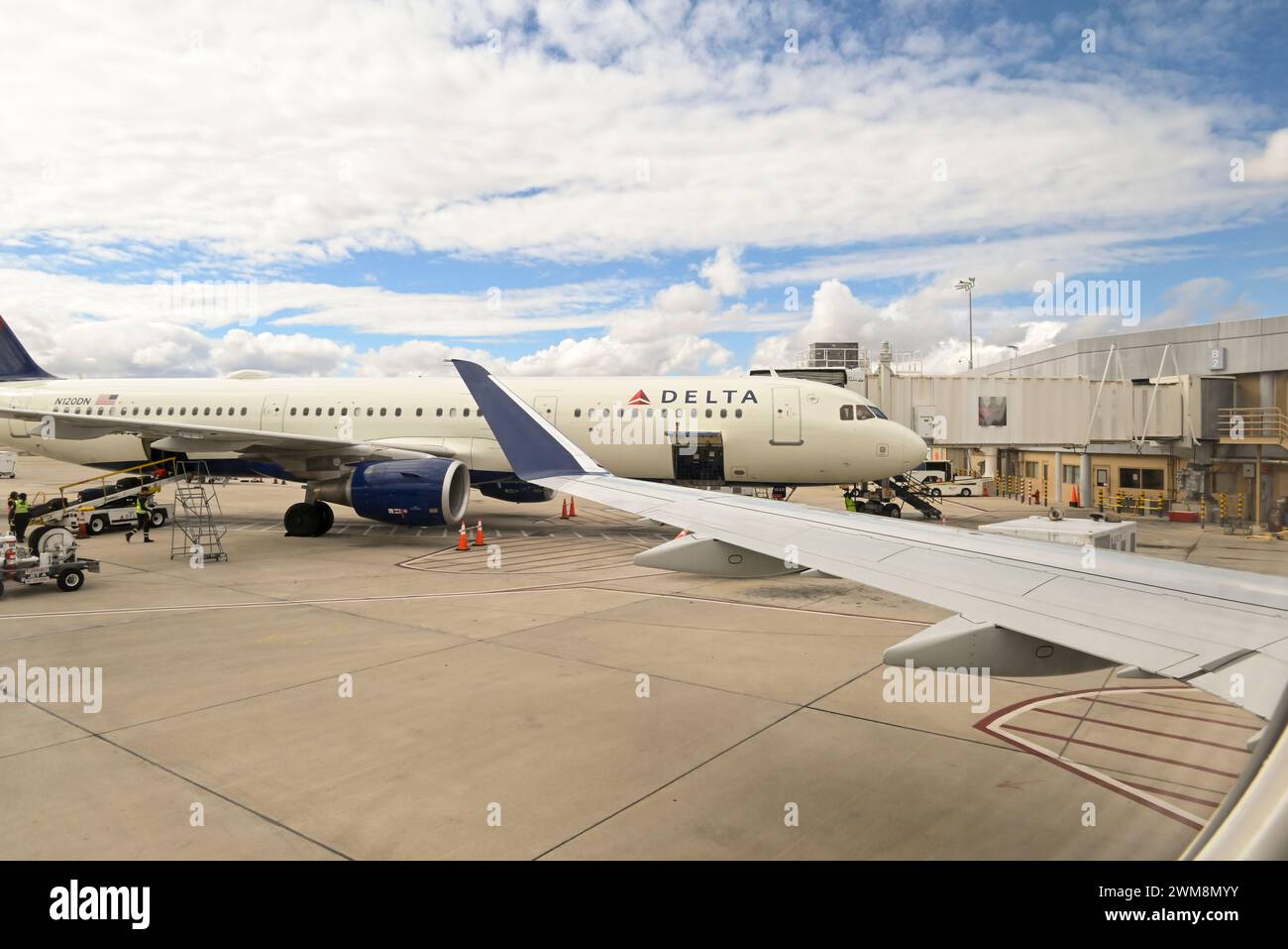 Delta Airlines plane at gate on cloudy day at TUS, Tucson International airport, Tucson, AZ, USA Stock Photo