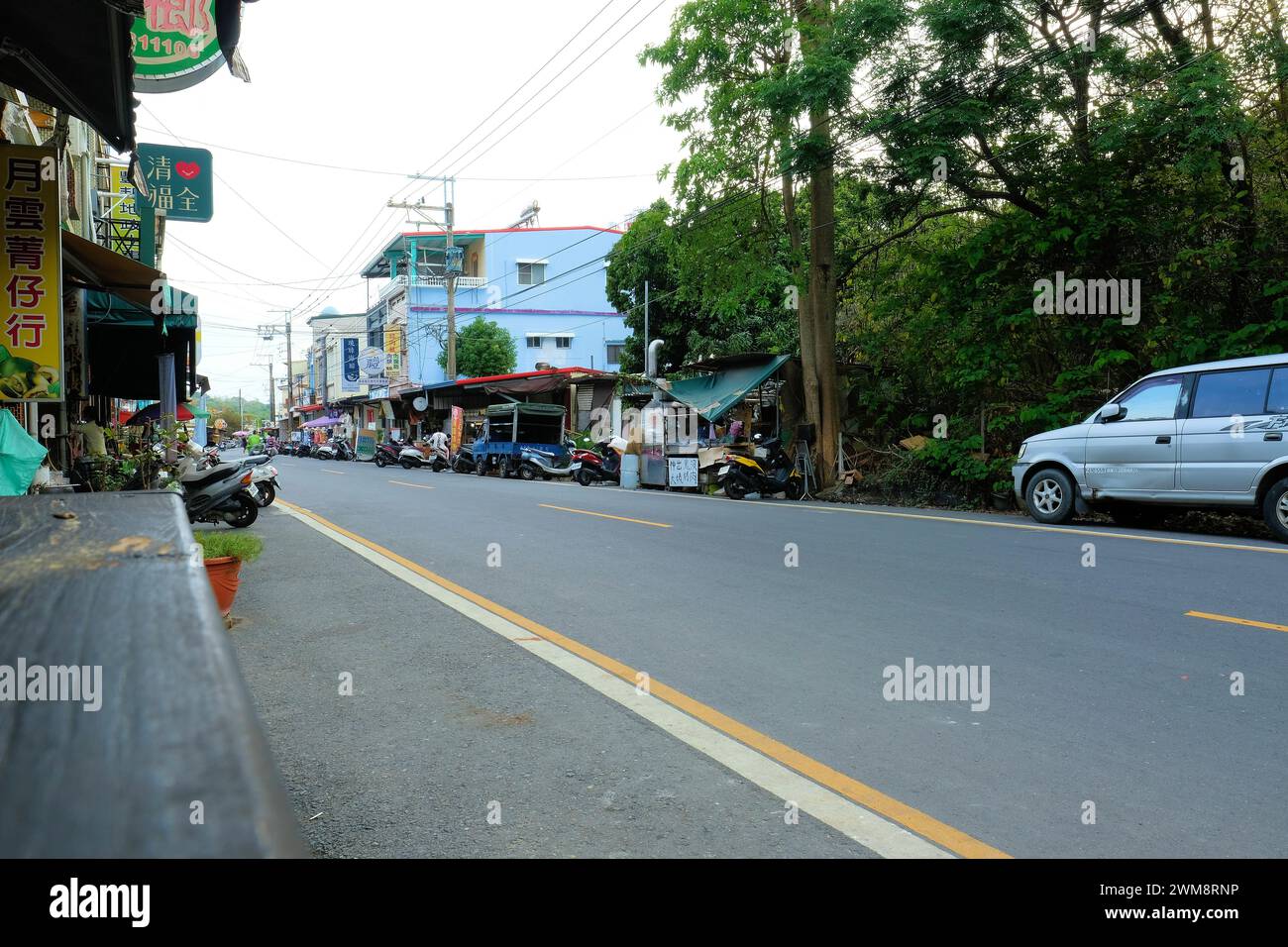 Zhongshan Road on Liuqiu island, off the coast of Taiwan; major roadway with local businesses and shops and power lines above structures. Stock Photo