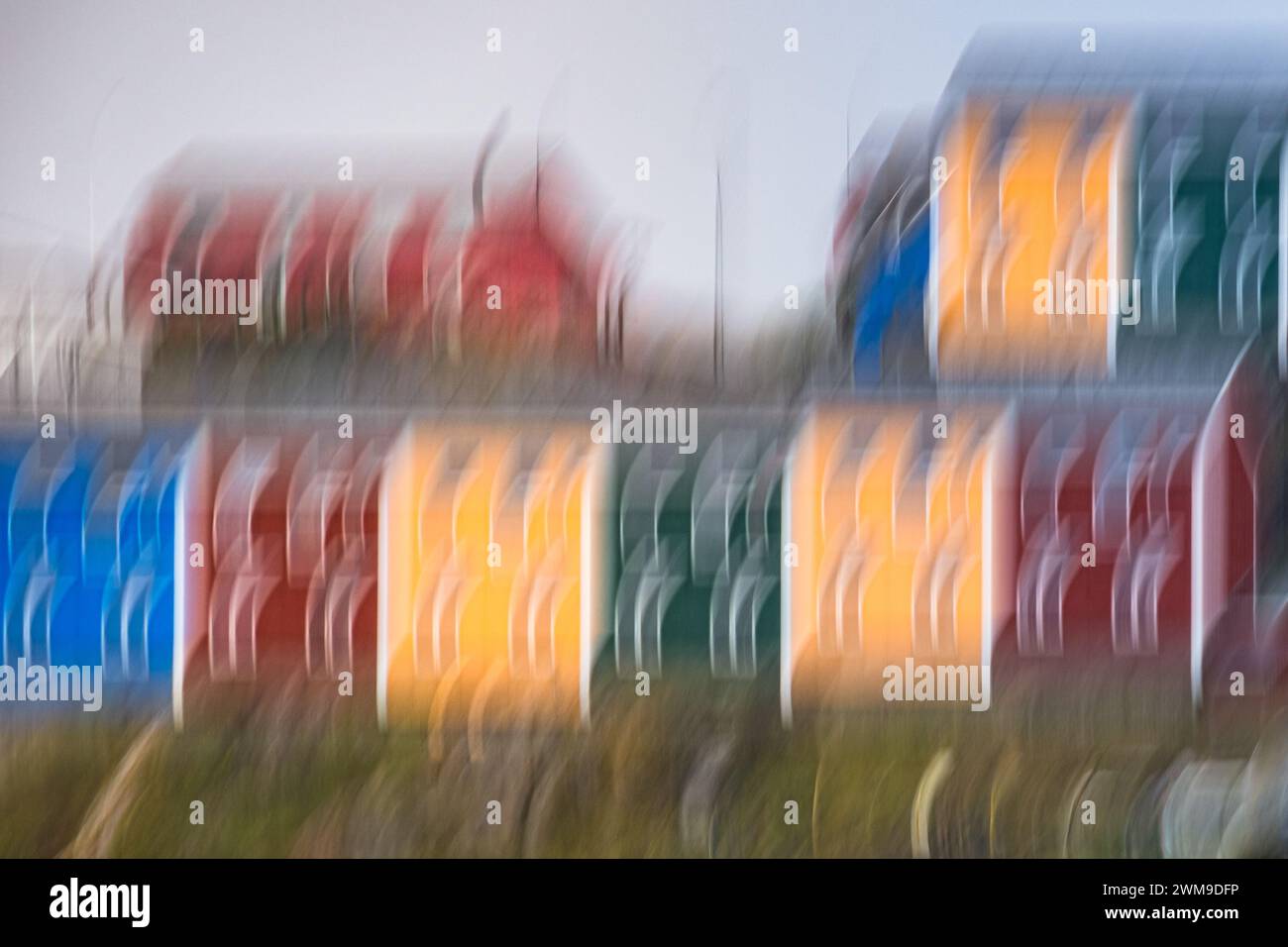 Intentional Camera Movement (ICM) creates unique patterns of houses in Sisimiut that are painted in bright reds, yellows, blues and greens. Stock Photo