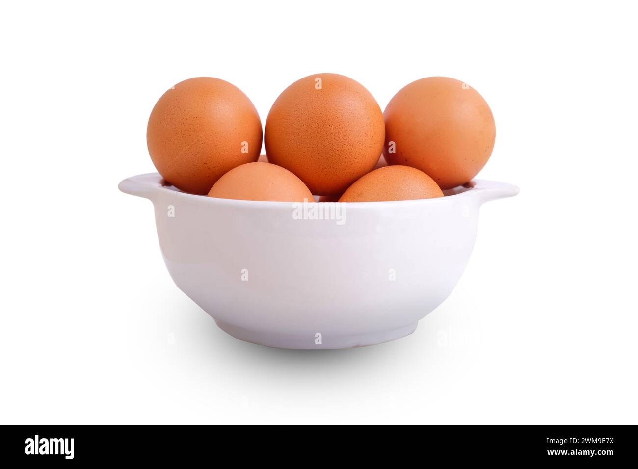 Fresh chicken eggs in a white bowl on a white background Stock Photo
