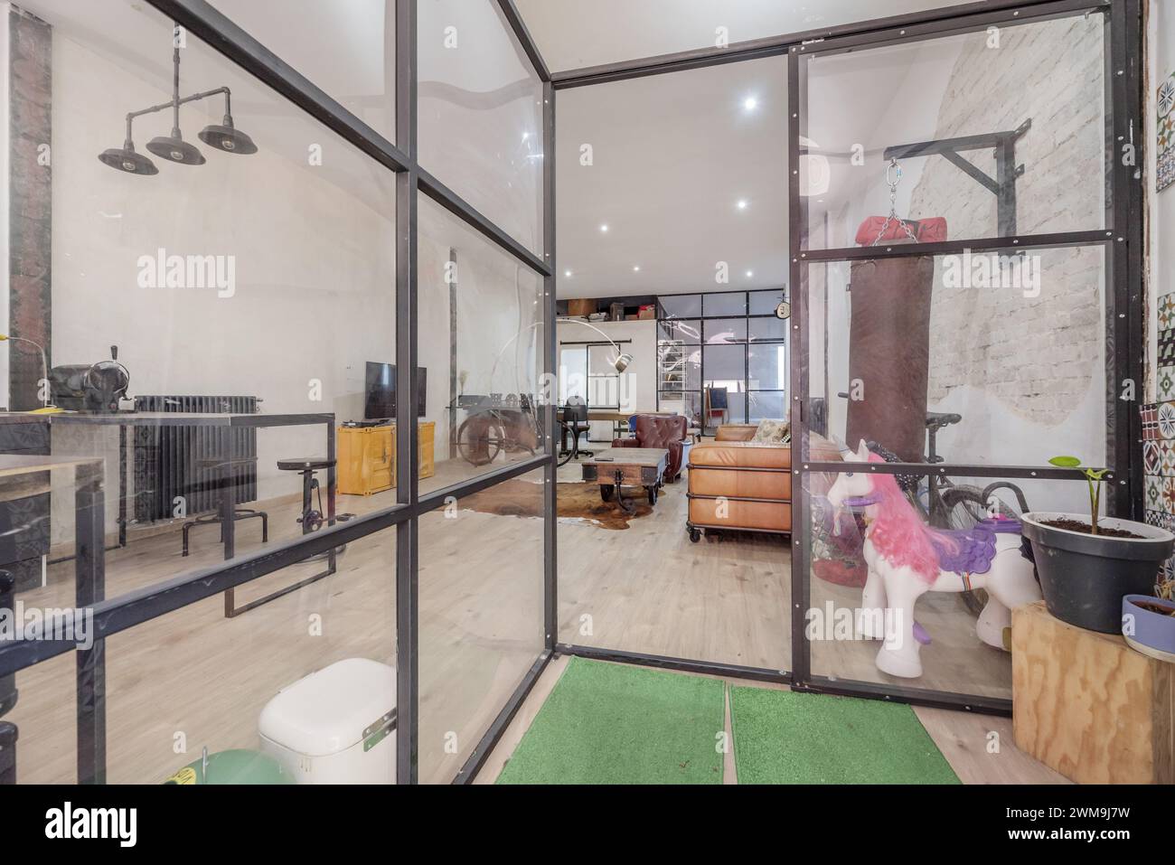 Hallway of a loft apartment with industrial-type decoration with a ...
