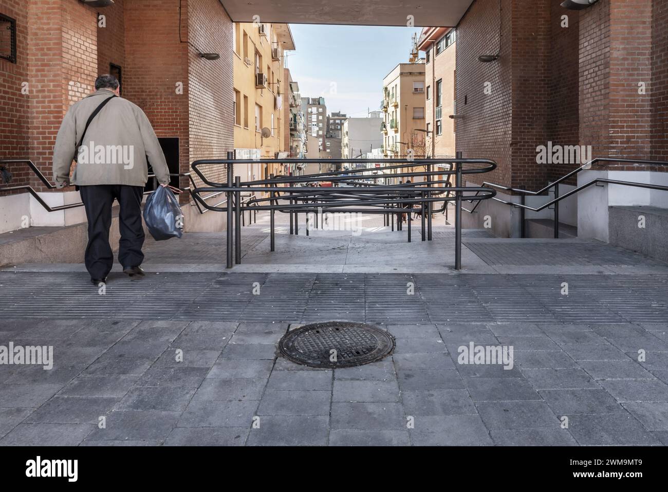 Passage with stairs to descend on a ramp Stock Photo - Alamy