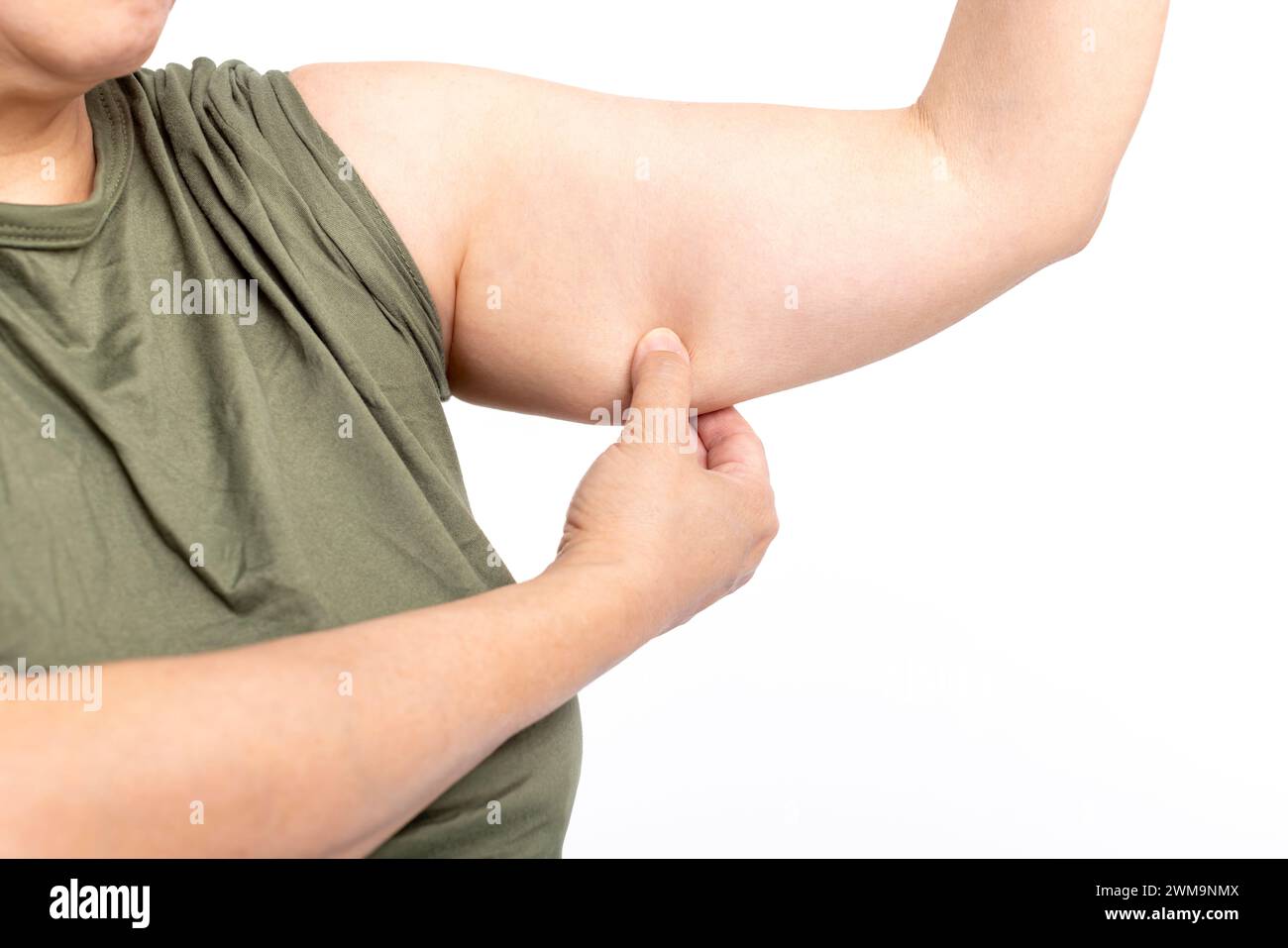 Woman checking her upper arm and excess fat Stock Photo