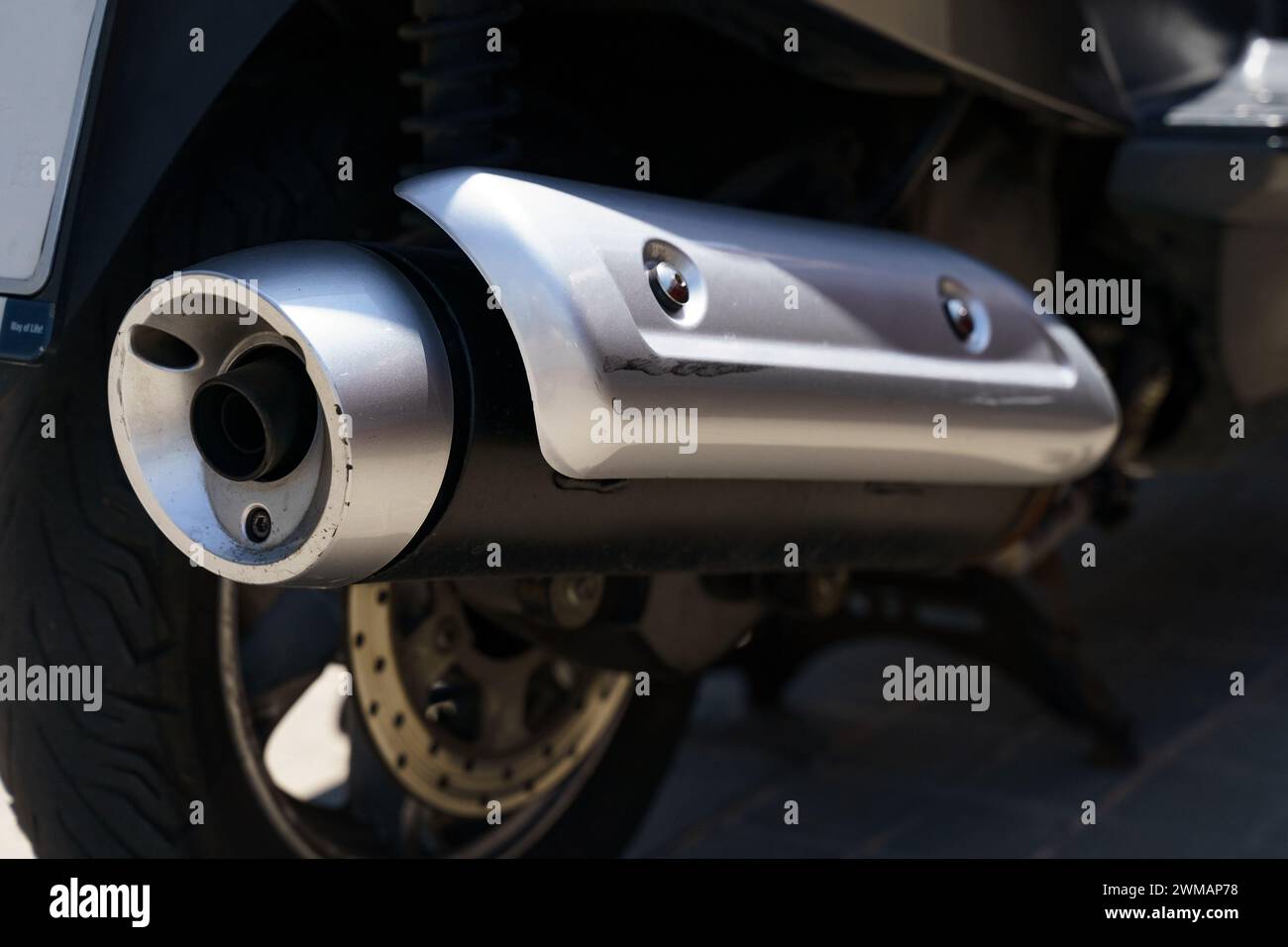 The image shows a detailed closeup of a motorcycles exhaust system