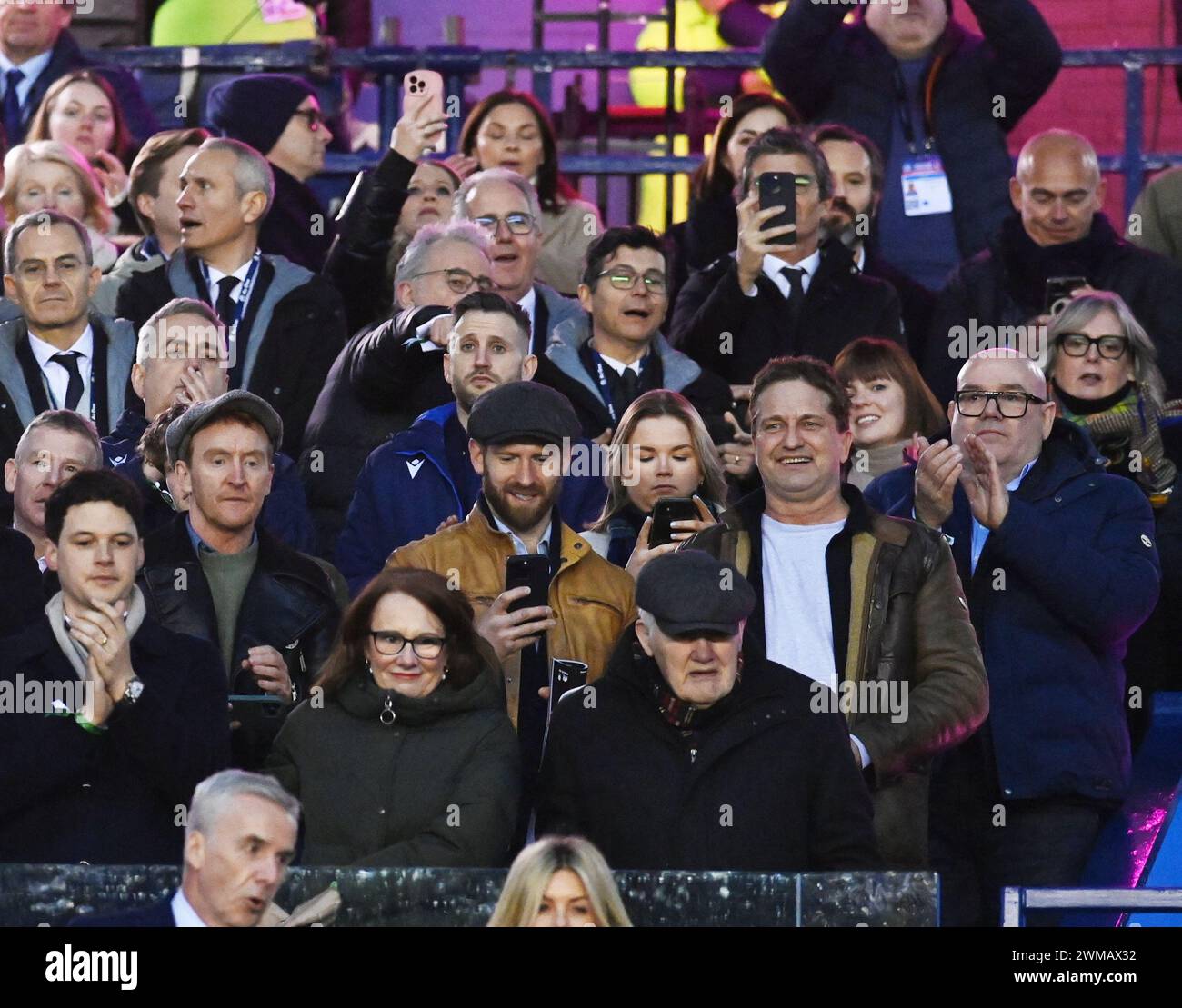 Scottish Gas Murrayfield Stadium. Edinburgh, UK. 24th Feb, 2024. UK.The Mens Guinness Six Nations match Scotland vs England Hollywood star Scottish actor Gerard Butler (White Tee Shirt) watching Scotland-England rugby match as he takes break from filming in Northern Ireland . Credit: eric mccowat/Alamy Live News Stock Photo