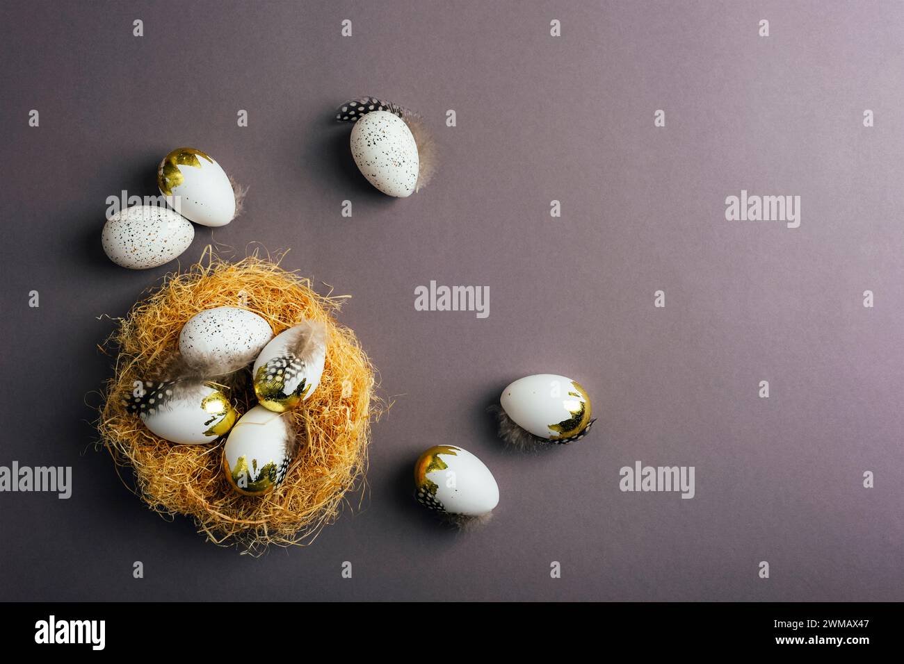 Basket with Easter eggs on dark gray background. Easter concept. Top view, flat lay, copy space. Stock Photo