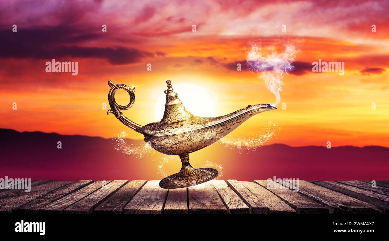 Precious golden magic lamp and sunset sky, fairy tales and wish fulfillment concept Stock Photo