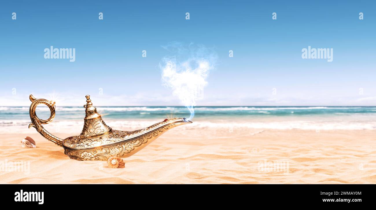 Magical Genie's lamp on the beach sand, fantasy and fairy tales concept Stock Photo