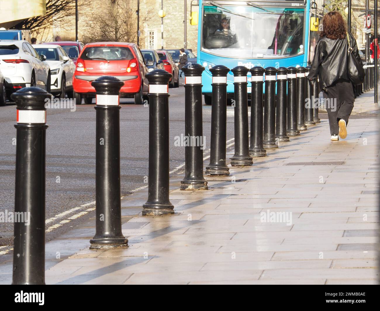 Bollards protecting pedestrians walking on pavement from motor traffic in St. James’s Parade, Bath, Somerset. Stock Photo