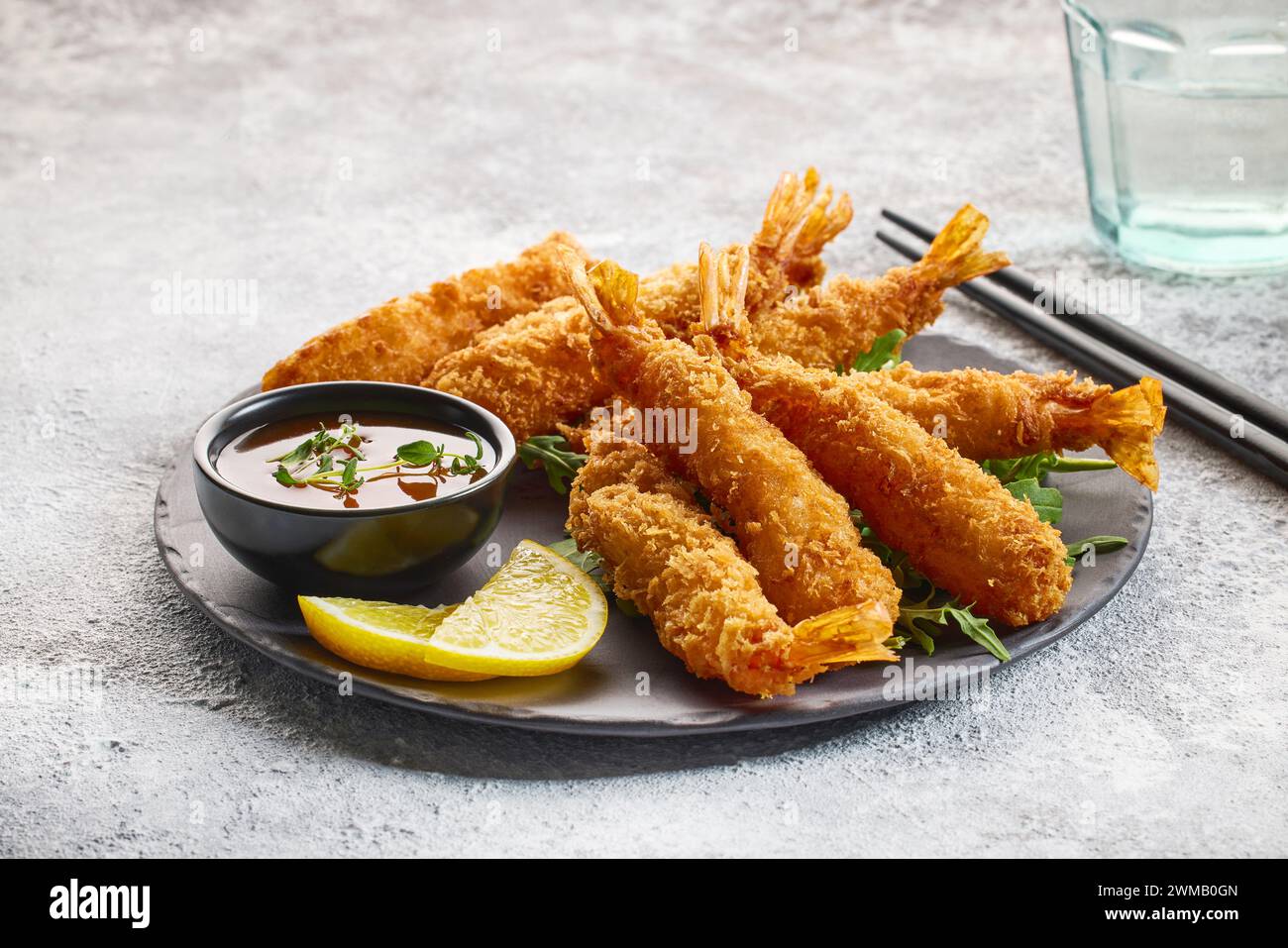plate of breaded Torpedo shrimps on grey pai nted kitchen table