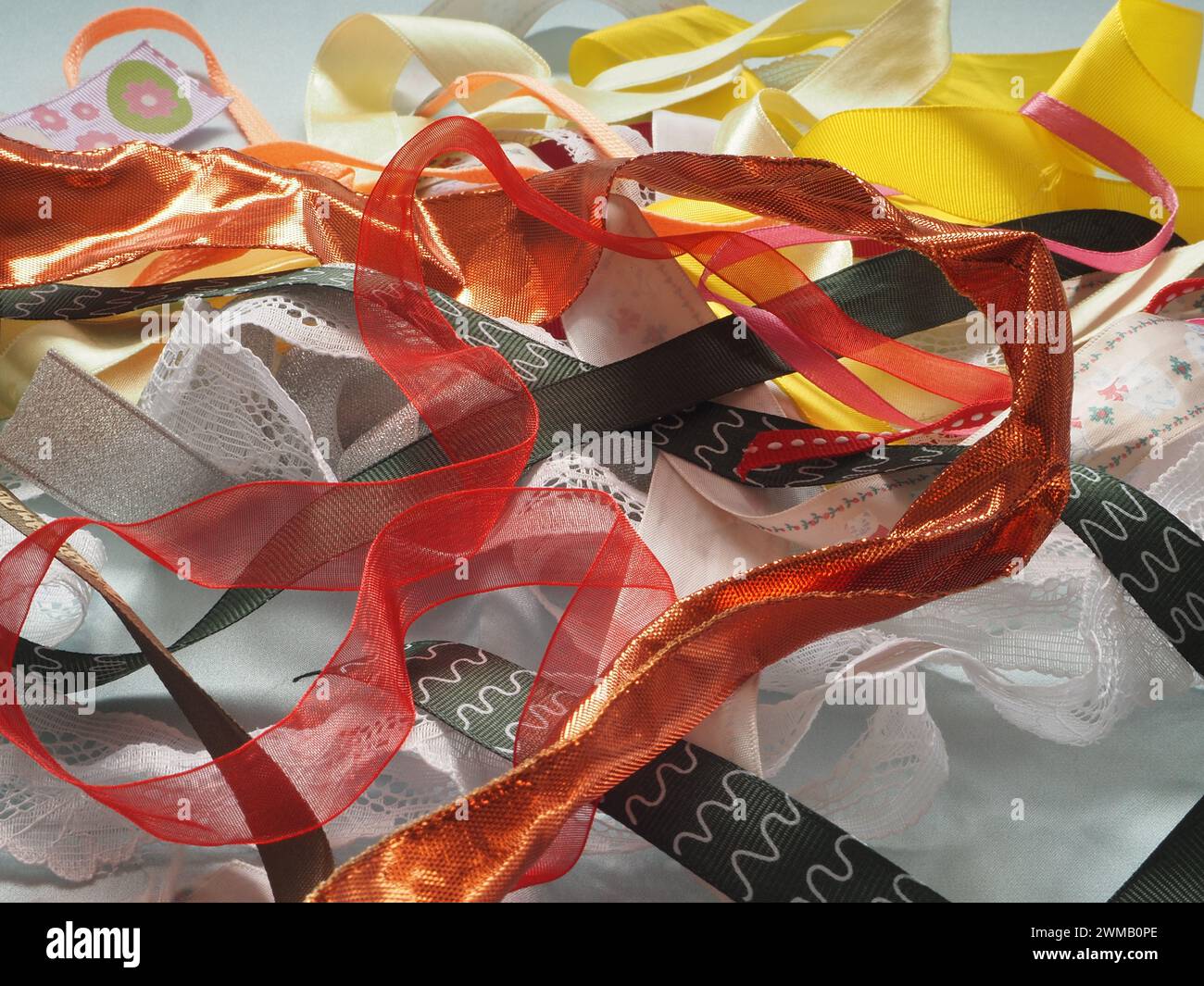 A selection of coloured ribbons scattered in a random fashion on a ...