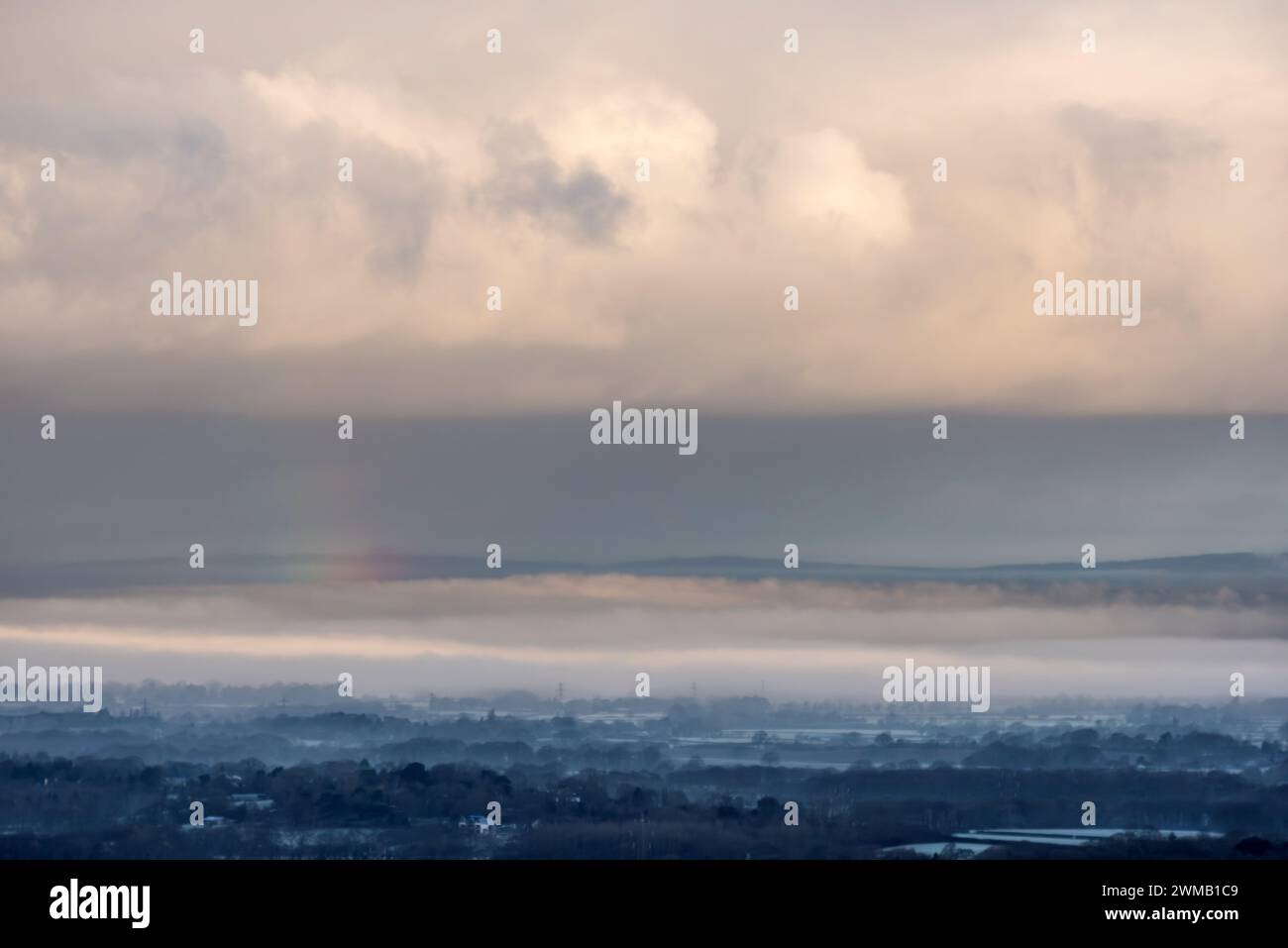 Brighton, February 25th 2024: Low-lying mist on the Weald of Sussex, seen from Devil's Dyke, in the South Downs National Park at sunrise this morning Credit: Andrew Hasson/Alamy Live News Stock Photo