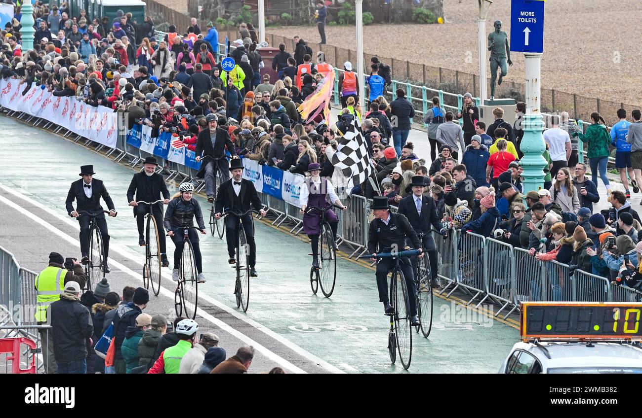 Brighton UK 25th February 2024 - Penny Farthing riders lead the way as thousands of runners take part in the Brighton Half Marathon on a cold chilly morning along the South Coast : Credit Simon Dack / Alamy Live News Stock Photo