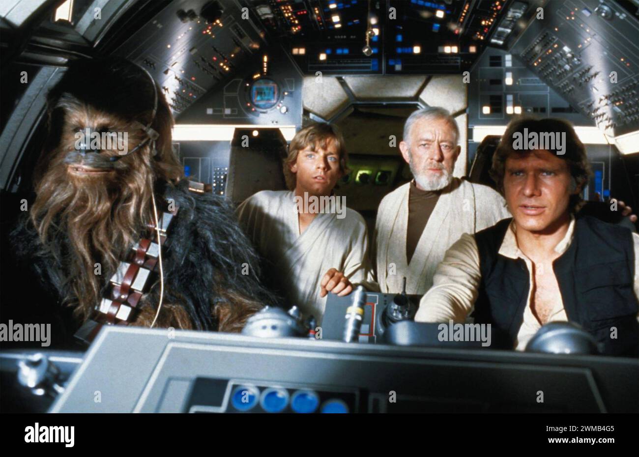 STAR WARS EPISODE IV - A NEW HOPE 1977 20th Century Fox sci-fi film with from left: Peter Mayhew ( Chewbacca), Mark Hamill(Luke Skywalker), Alec Guinness   (Obi-Wan Kenobi), Harrison Ford (han Solo) Stock Photo