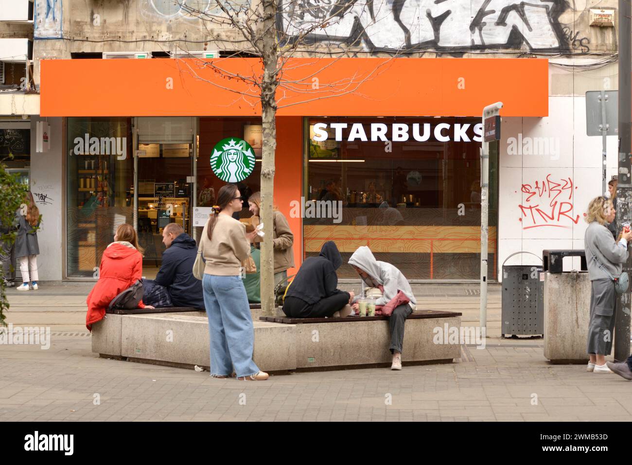 Teenagers hanging out in front of the Starbucks coffee shop at Slaveykov Square in Sofia, Bulgaria, Eastern Europe, Balkans, EU Stock Photo