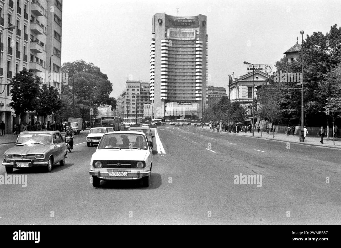 Bucharest, Romania, approx. 1980.  Vehicles driving on Boulevard I.C. Bratianu through the University Square, with the Intercontinental Hotel seen in the back. Stock Photo