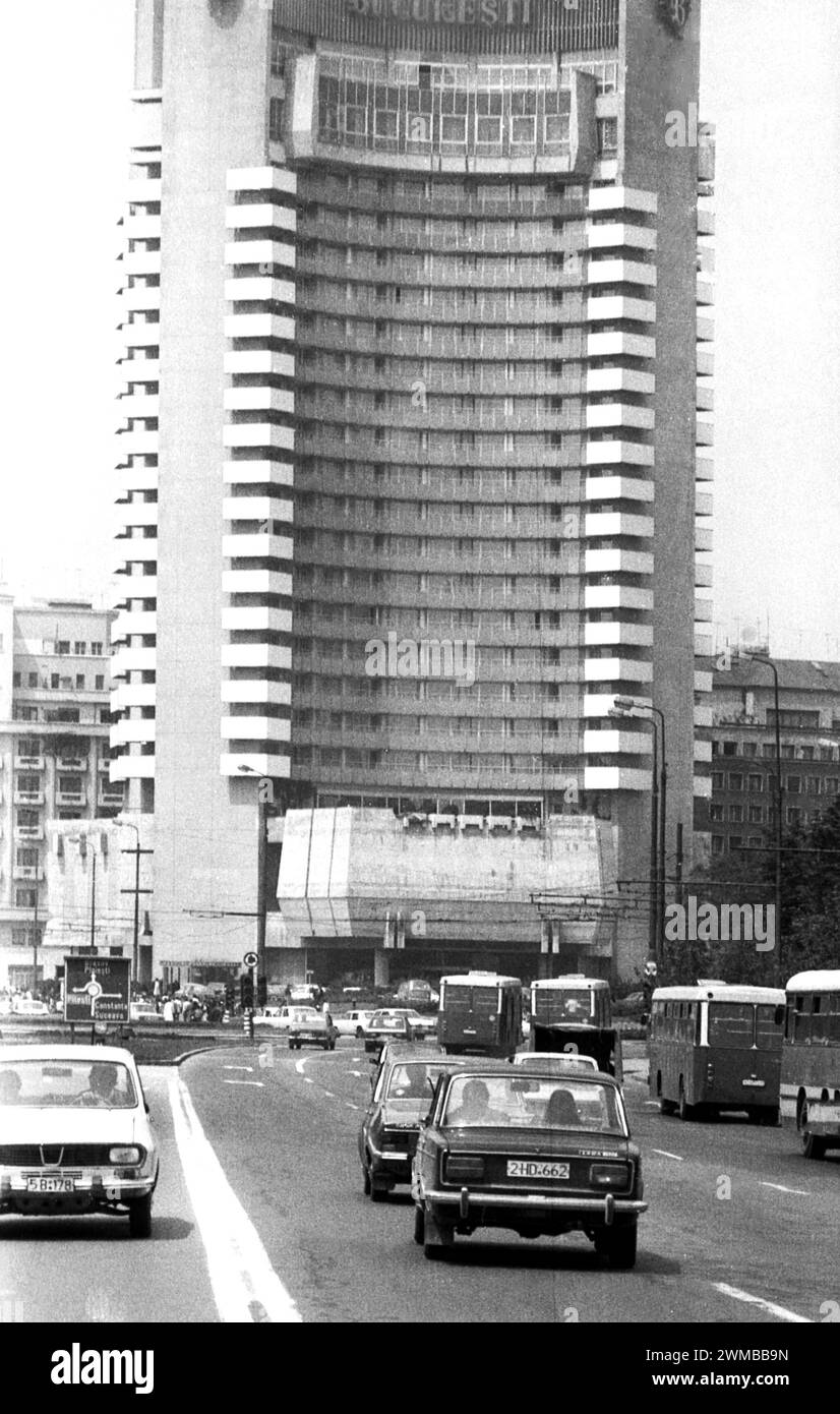 Bucharest, Romania, approx. 1980.  Vehicles driving on Boulevard I.C. Bratianu through the University Square, with the Intercontinental Hotel seen in the front. Stock Photo
