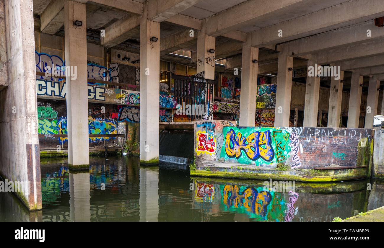 Graffiti and spray can paint artwork along the Fazeley canal in the
