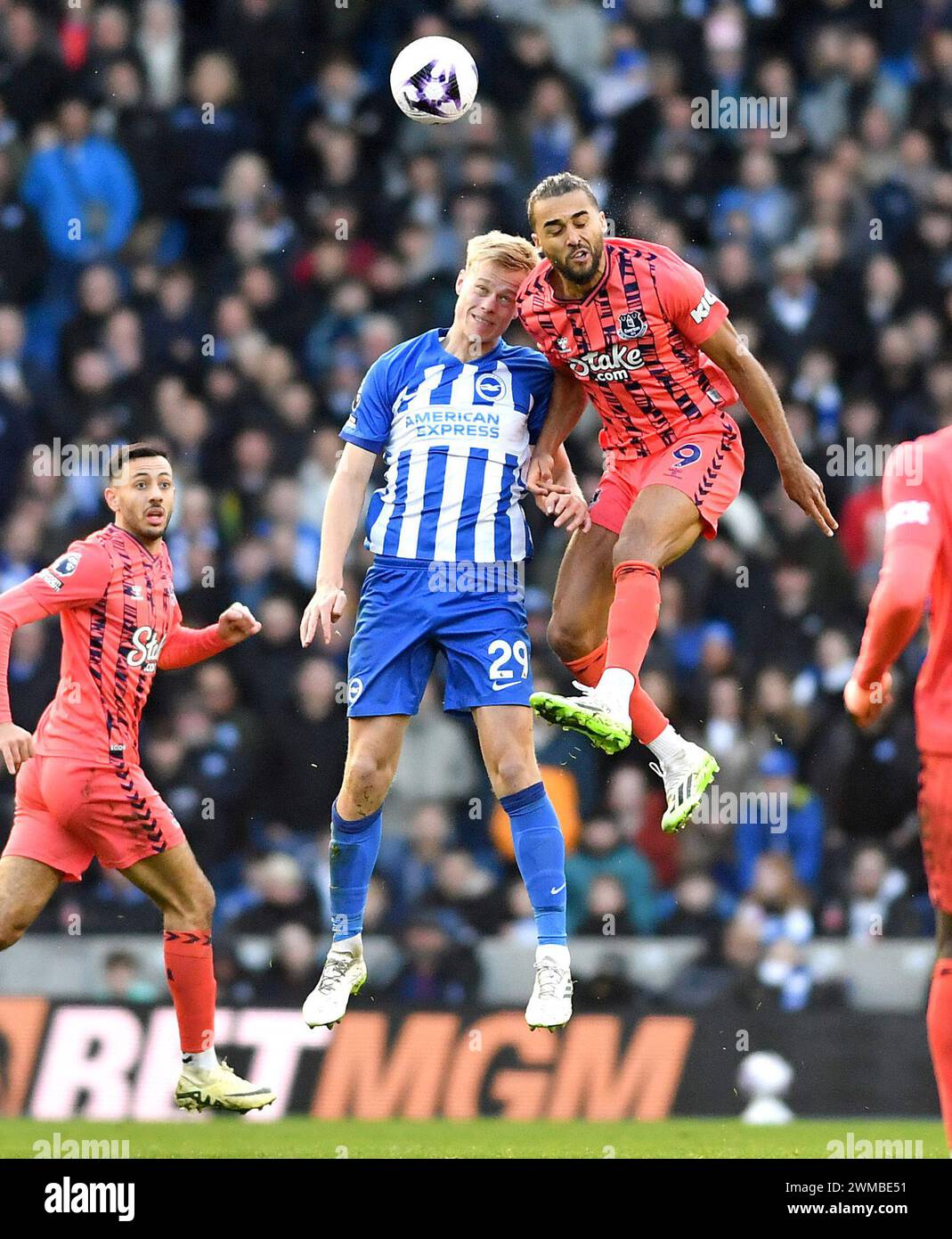Dominic Calvert-Lewin of Everton battles with Jan Paul van Hecke of Brighton in the air during the Premier League match between Brighton and Hove Albion and Everton at the American Express Stadium  , Brighton , UK - 24th  February  2024  Photo Simon Dack / Telephoto Images Editorial use only. No merchandising. For Football images FA and Premier League restrictions apply inc. no internet/mobile usage without FAPL license - for details contact Football Dataco Stock Photo
