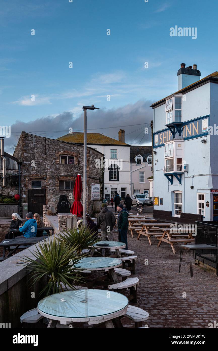 The Ship Inn at Teignmouth, Devon , England, UK with outside seating and people drinking on an early evening in winter. Portrait format Stock Photo
