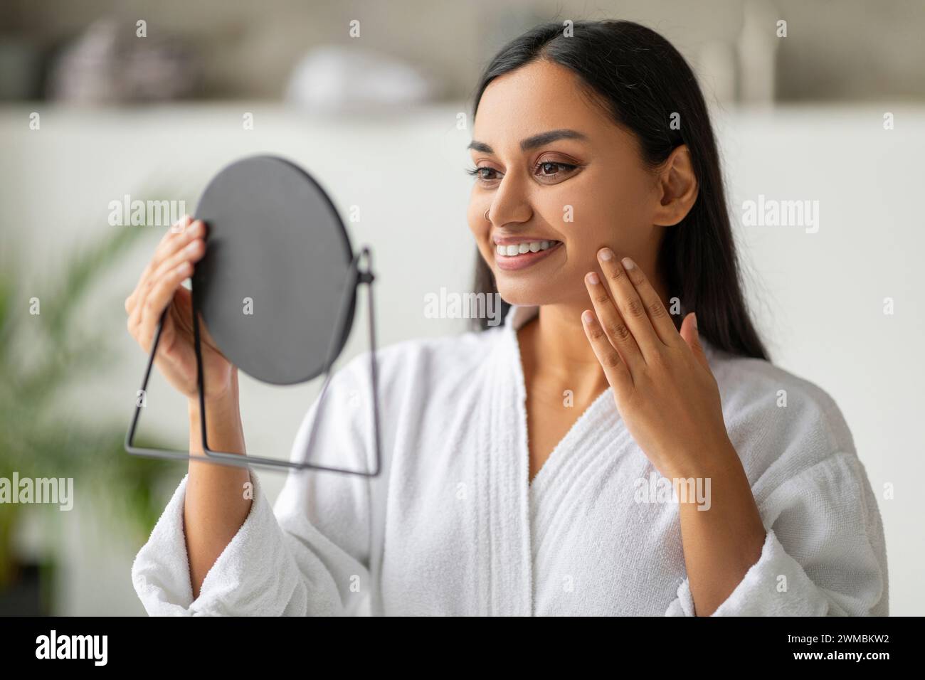 Woman looking in hand mirror hi-res stock photography and images - Alamy