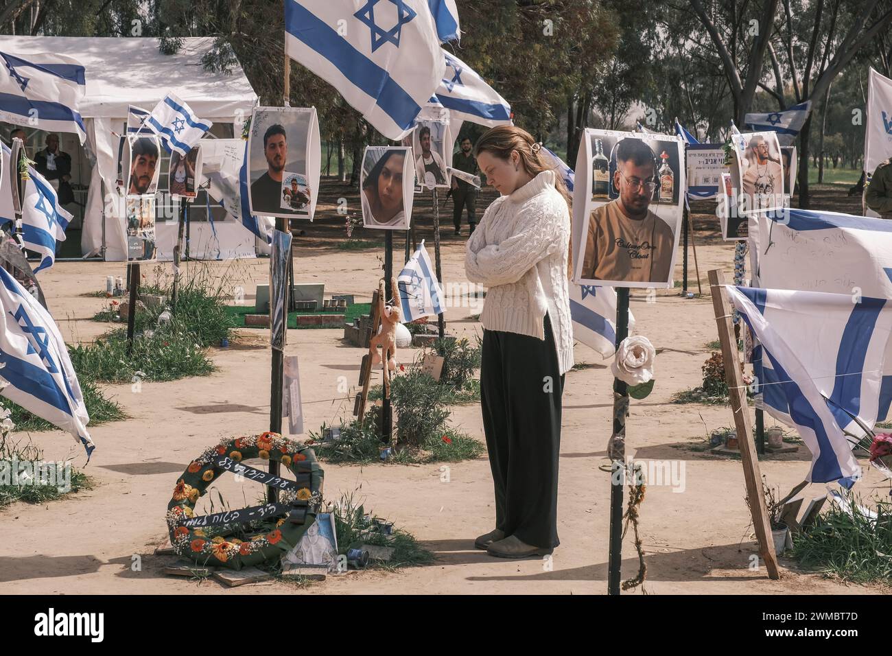 Kibbutz Reim, Israel. 25th Feb, 2024. Visitors join grieving families to pay respect to the victims of the October 7th, 2023, Nova Music Festival Massacre near Kibbutz Reim. 364 festival participants were shot, beaten or burned to death, some following abuse and rape, by infiltrating Palestinian Hamas gunmen from Gaza into Israeli territory. Credit: Nir Alon/Alamy Live News Stock Photo