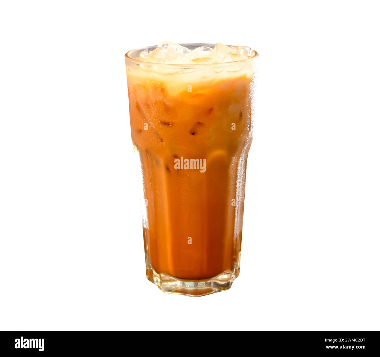 Iced orange Thai condensed milk Tea in transparent glass is isolated on white background with clipping path. Stock Photo
