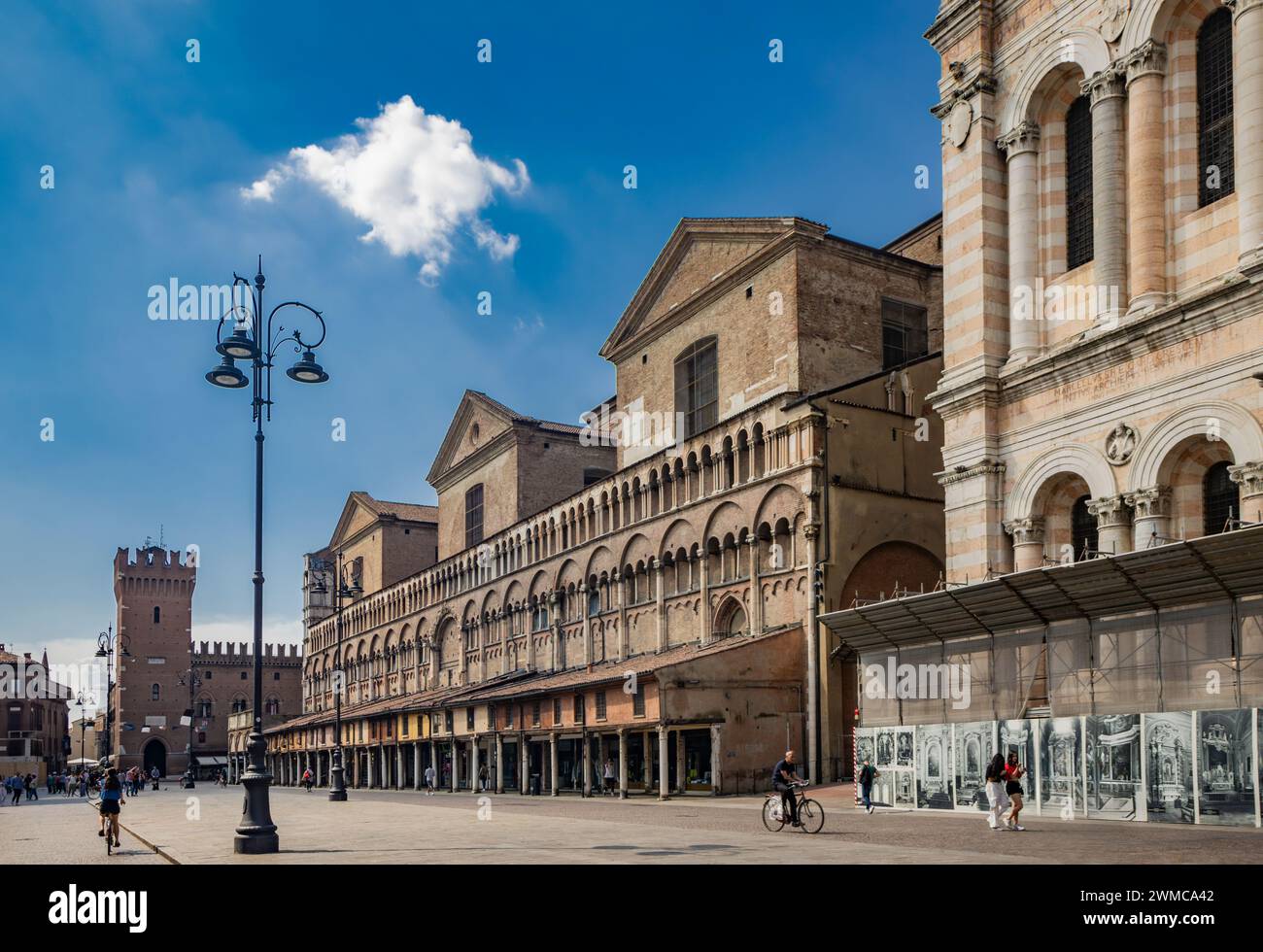 June 4, 2023 - Ferrara, Emilia Romagna, Italy. Piazza Trento e Trieste with the bell tower of the Cathedral of San Giorgio, its long portico and the T Stock Photo