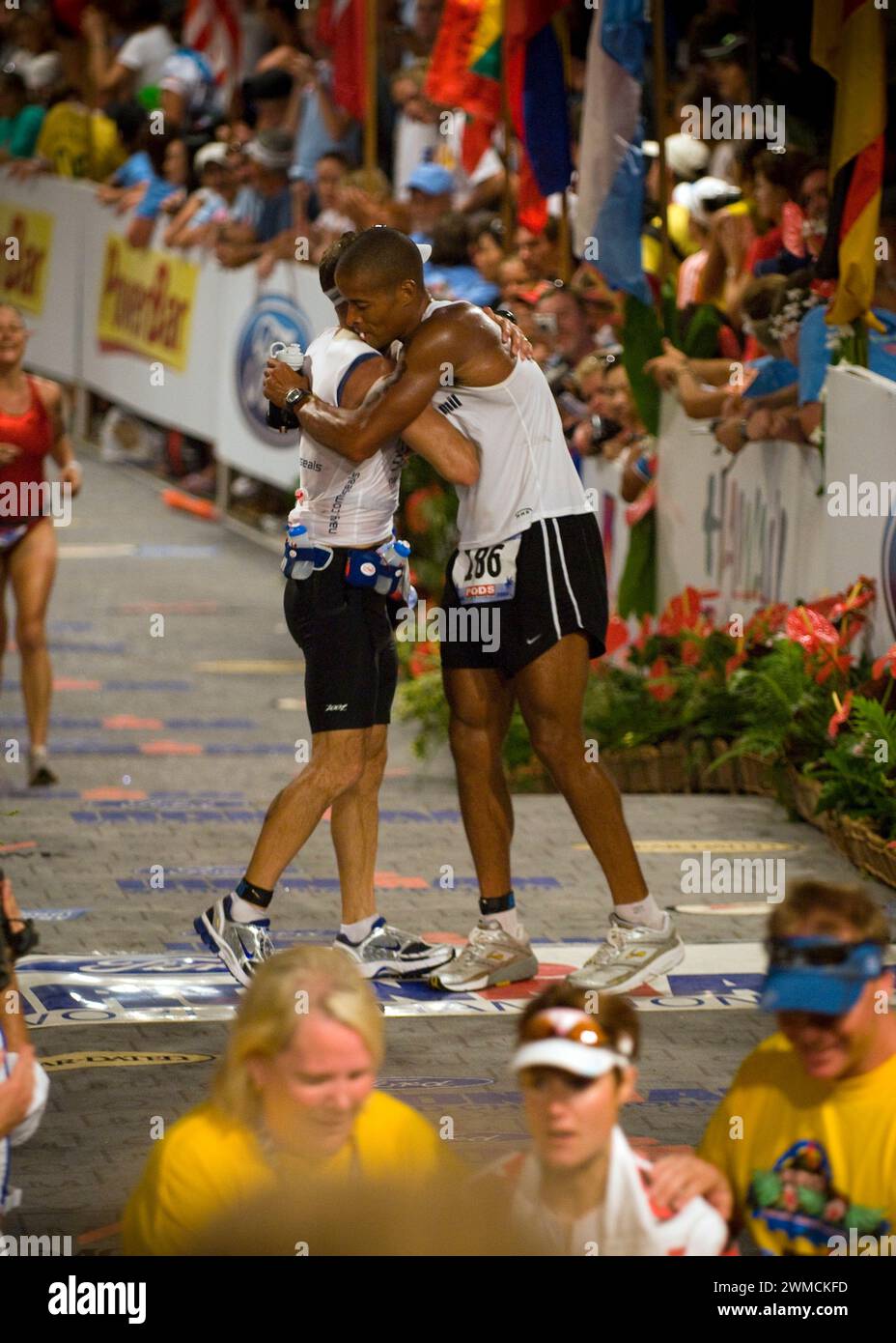 Kailua-Kona, United States of America. 11 October, 2008. U.S Navy Special Warfare Operator 1st Class David Goggins, right, embraces fellow Navy SEAL Cmdr. Keith Davids, commanding officer of SEAL Team One, as they cross the finish line together at the 30th Ford Ironman World Championship, October 11, 2008 in Kailua-Kona, Hawaii.  Credit: MC2 Paul Honnick/US Navy Photo/Alamy Live News Stock Photo
