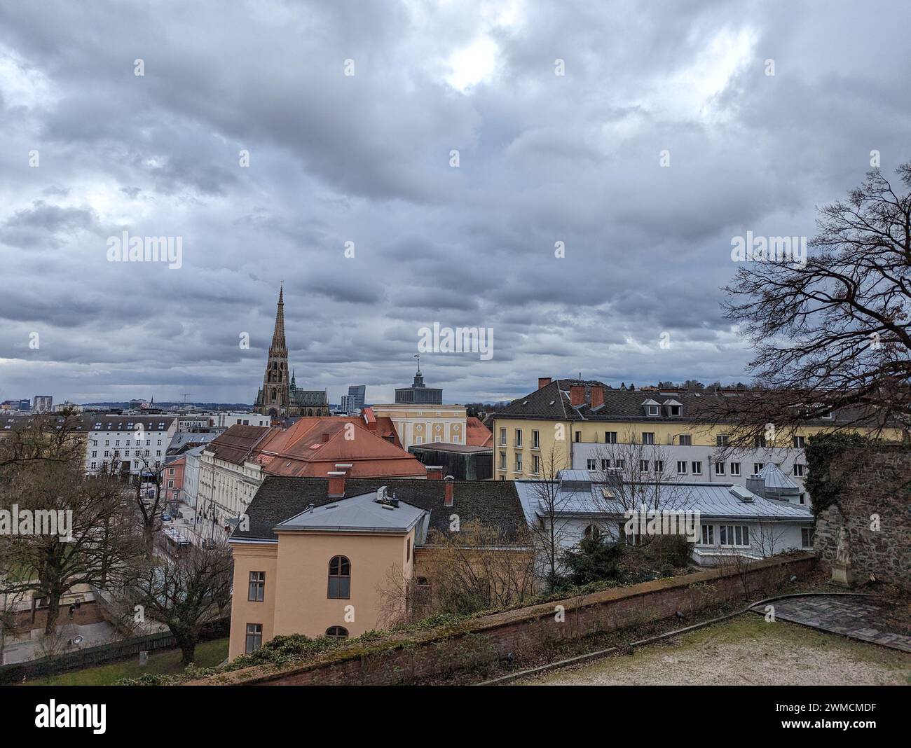 A medieval castle courtyard with city skyline view from rooftop in Linz ...