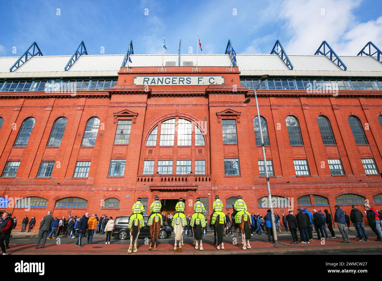 Police horses and mounted police giving security in Edminston Drive entrance to Ibrox Stadium, Rangers Football Club home ground, Glasgow, Scotland, U Stock Photo