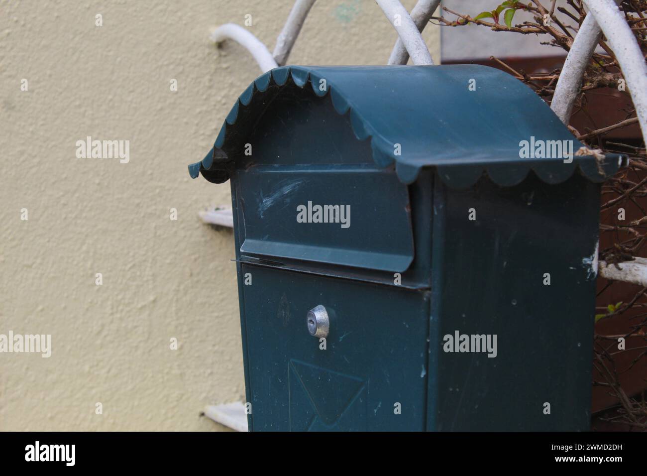 A close up photo fo a small letterbox beside a house gate Stock Photo ...