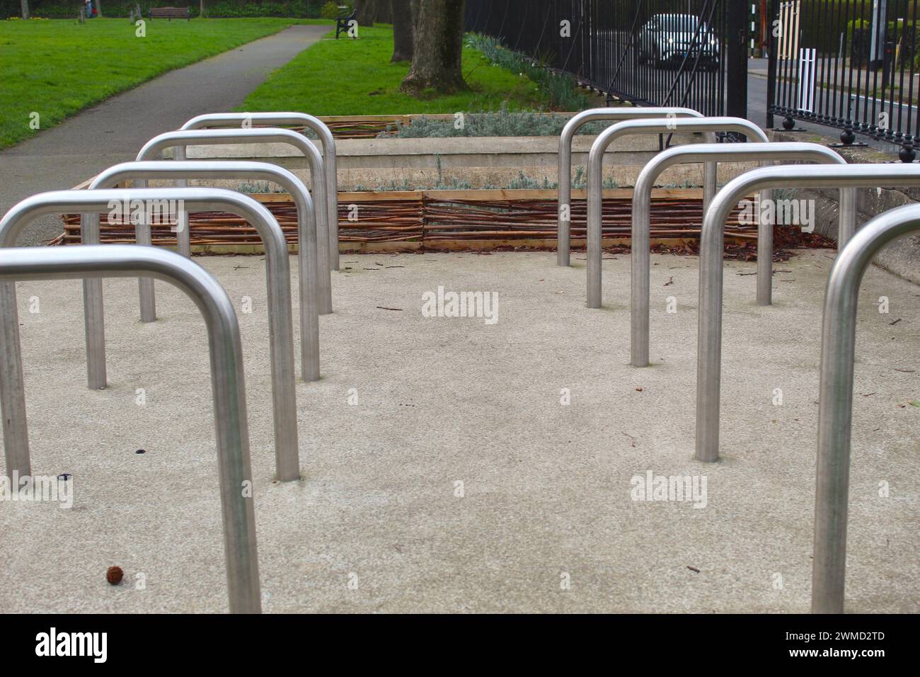 A photo of a group of bike parking metal racks lined up together on a path. Stock Photo