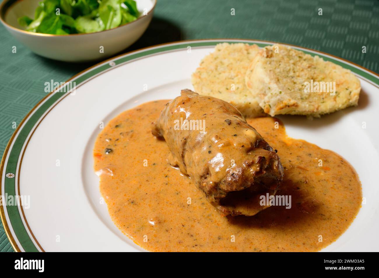 Beef Roulade or Rindsroulade with Semmelknodel Dumpling, Sour Cream Gravy with Green Field Salad Stock Photo