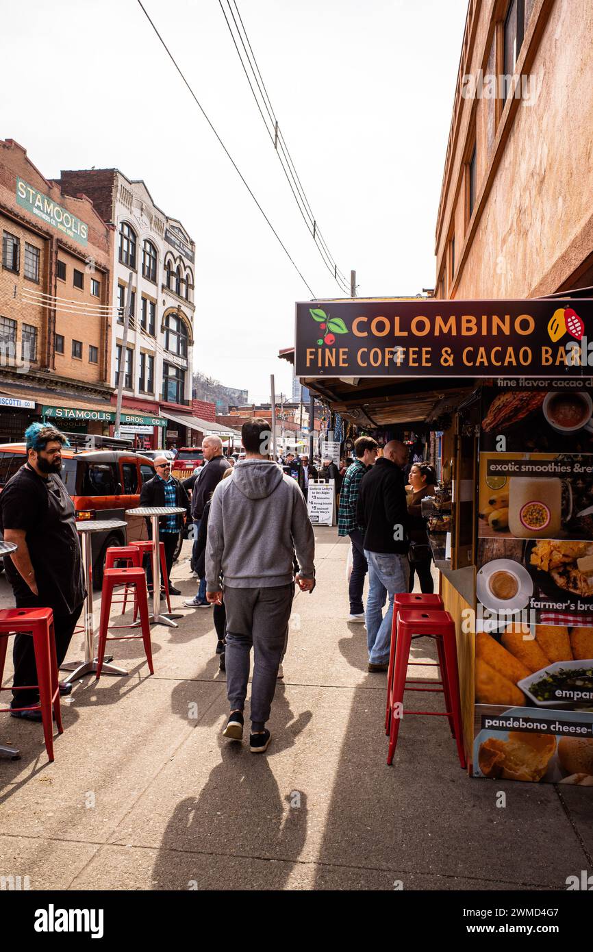 In Pittsburgh, PA, the bustling Strip District comes alive on a vibrant spring day, with locals and visitors alike immersed in the energetic atmospher Stock Photo