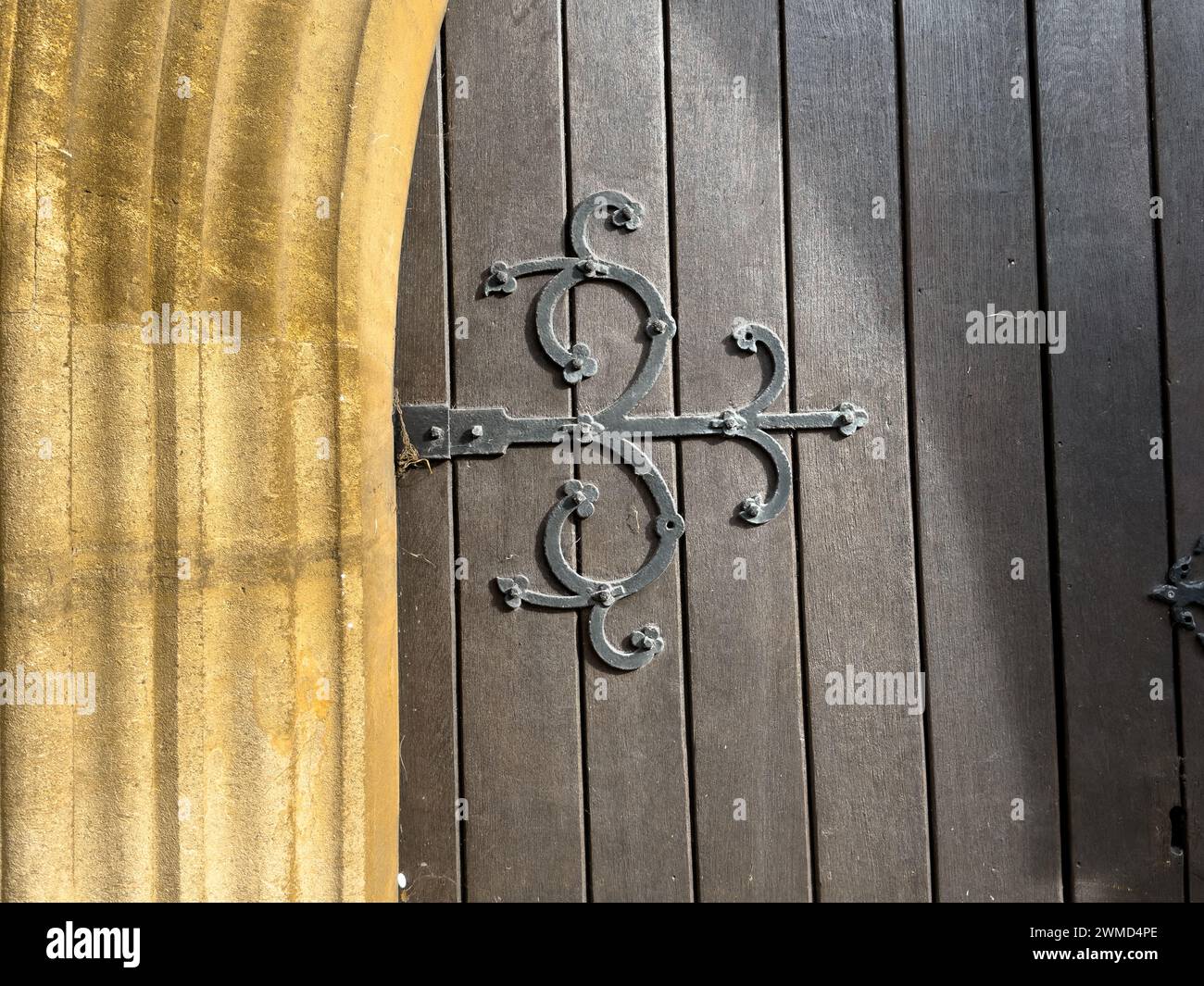 The image presents a close-up view of the wooden door of St. Mary's Church in Thatcham, Berkshire, adorned with decorative metal hardware. Constructed Stock Photo