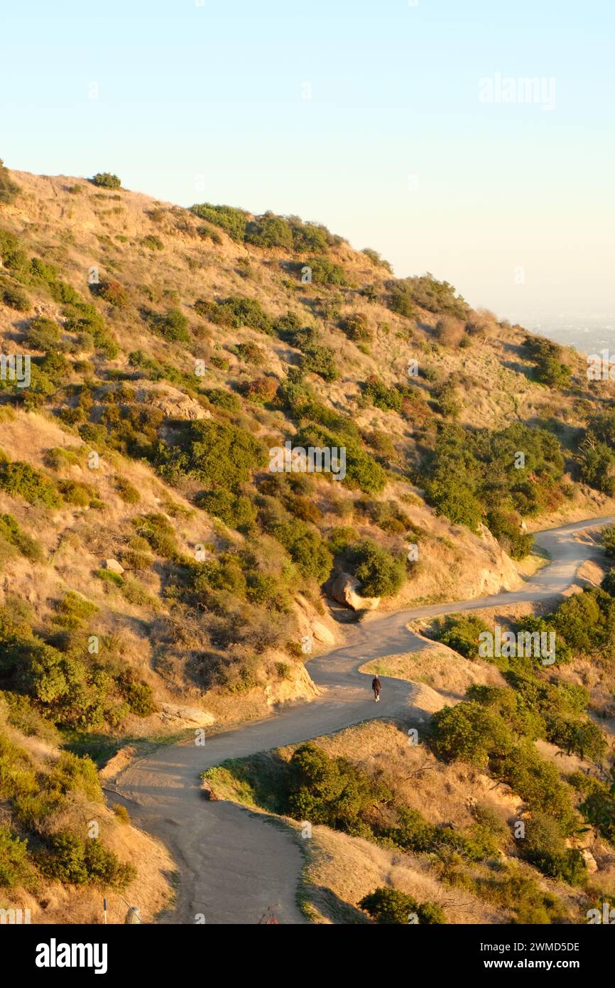 Aerial view of two individuals on a winding road above the scenery Stock Photo