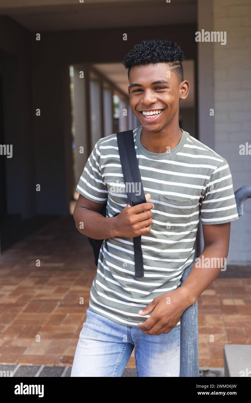 Teenage biracial boy smiling at high school Stock Photo - Alamy